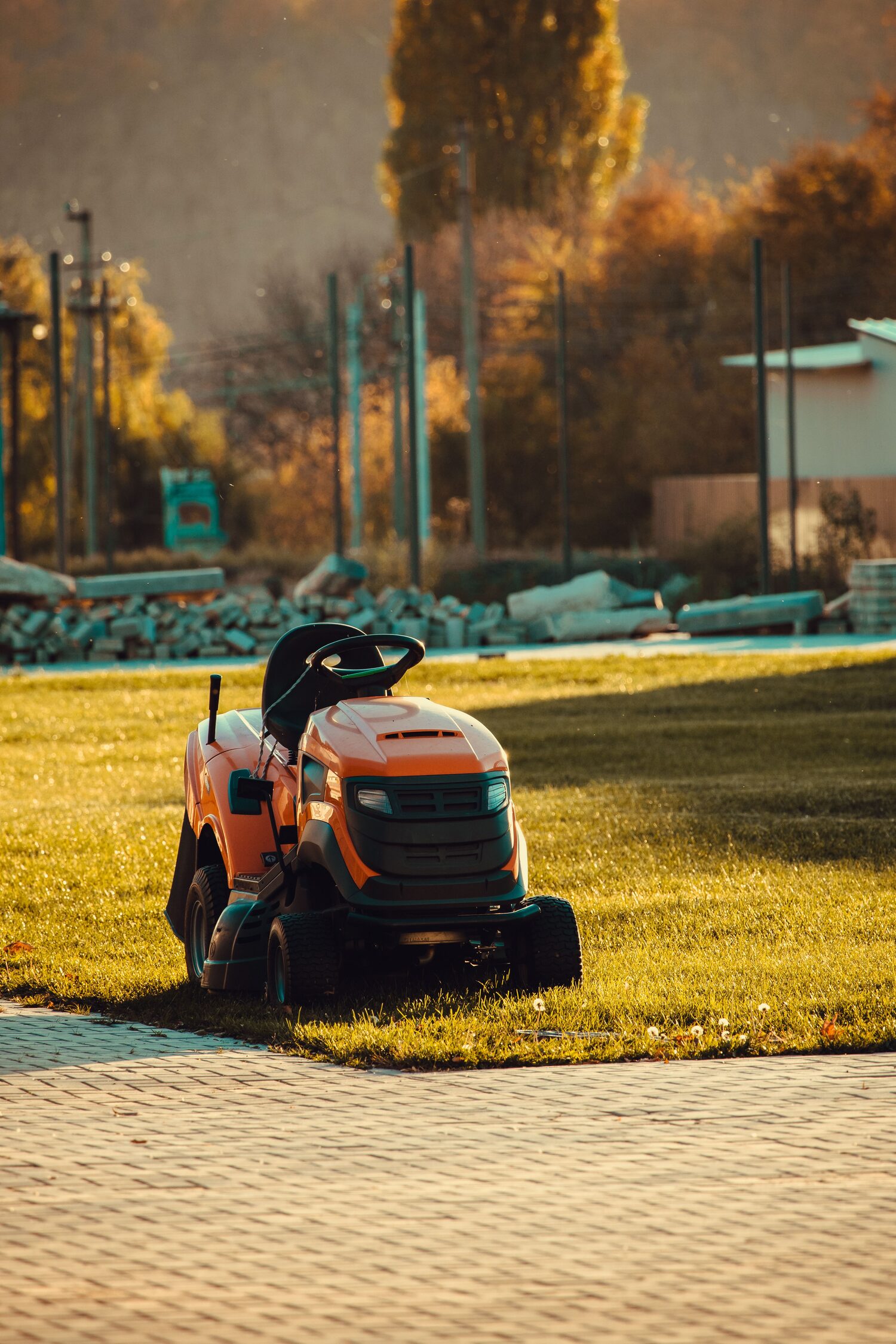 Ride-on mower on a freshly cut lawn at golden hour